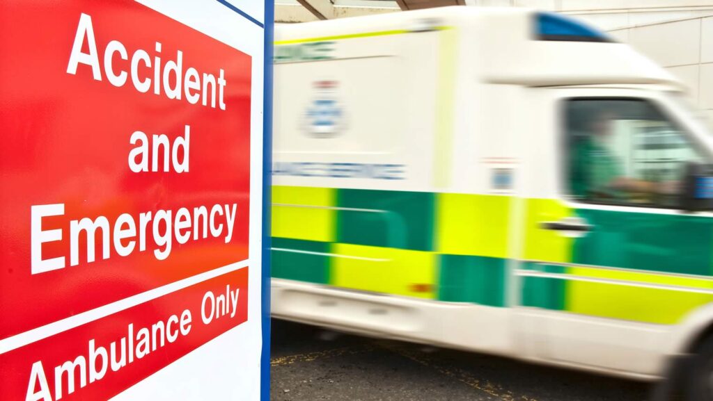 Emergency ambulance outside a hospital A & E accident and emergency department.